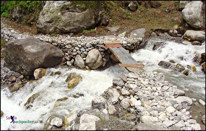 Makeshift bridge to cross a water-stream