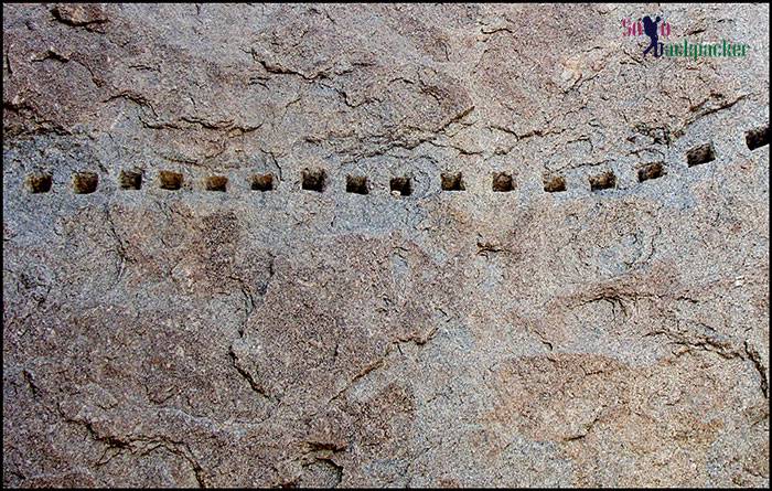 Drilled holes in the boulders